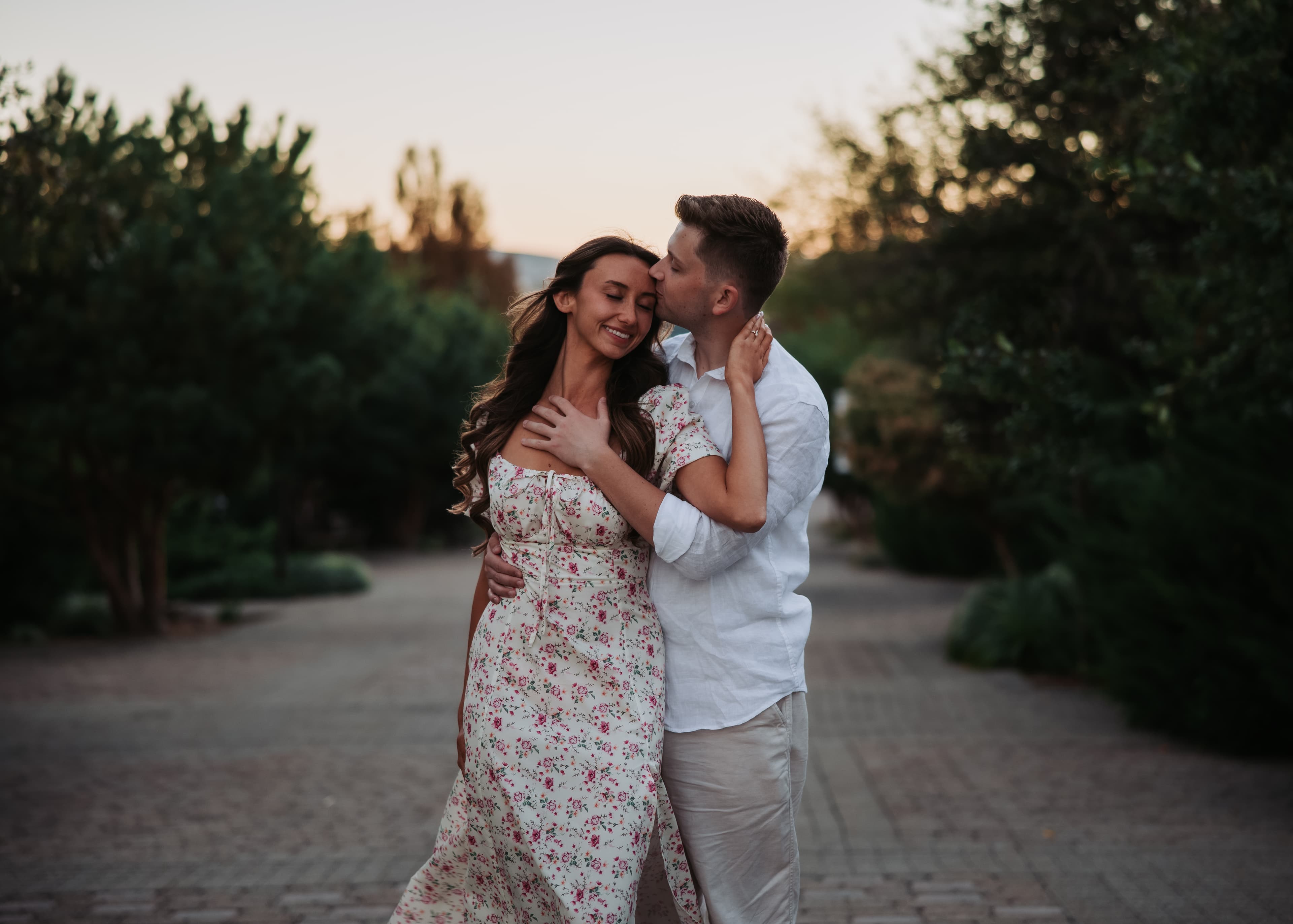 Bronson kissing Bre on the forehead in the soft evening light